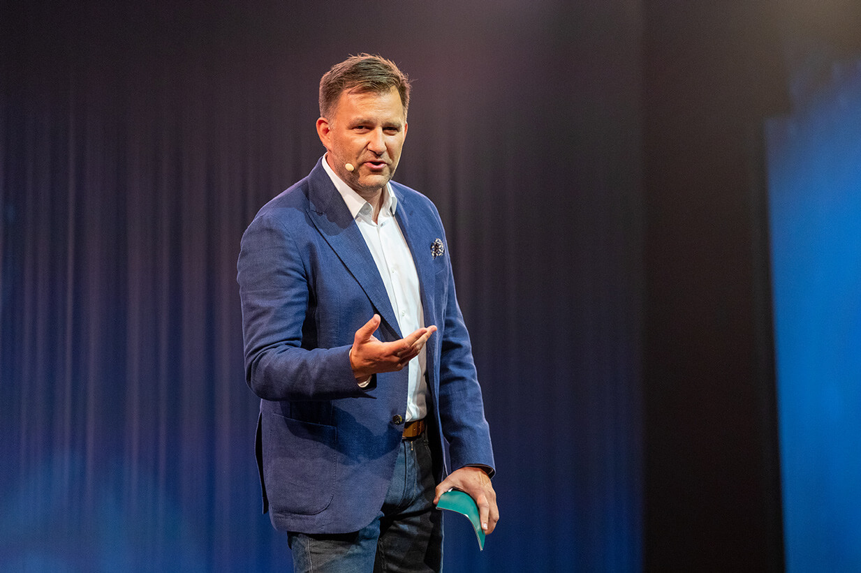 Moderator at an event in front of an audience