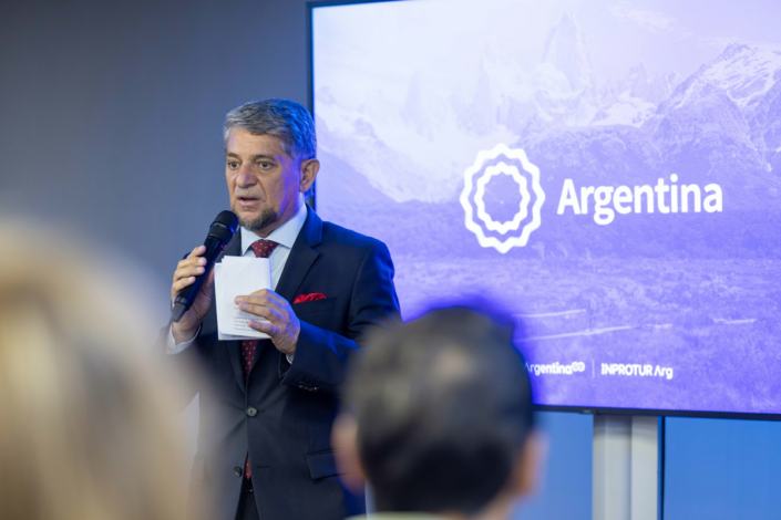 A man gives a lecture at an event in Argentina.
