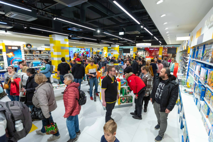 A crowd of people in a Lego store.