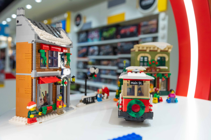 A Lego store with a Lego city on display.