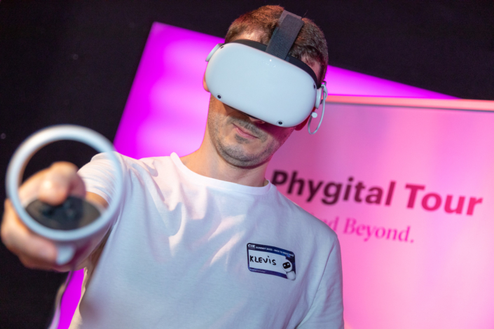 A man holds a virtual reality headset in his hand.