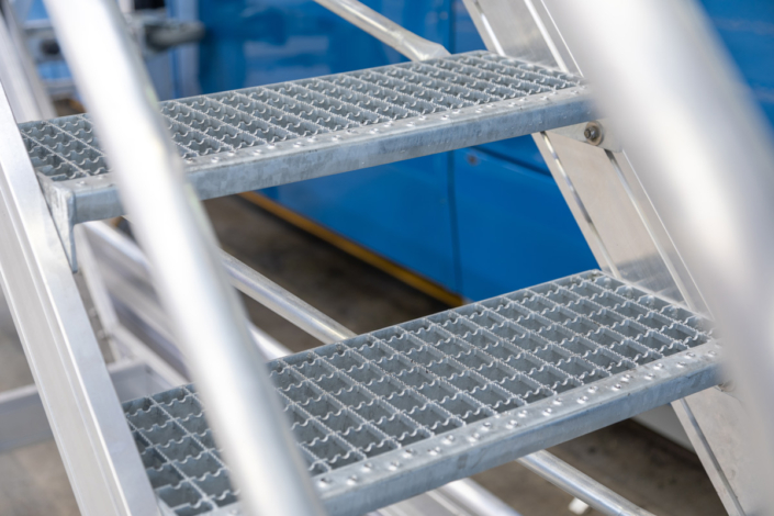 A picture of a metal ladder with a blue background.