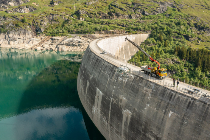A man works on the side of a dam.