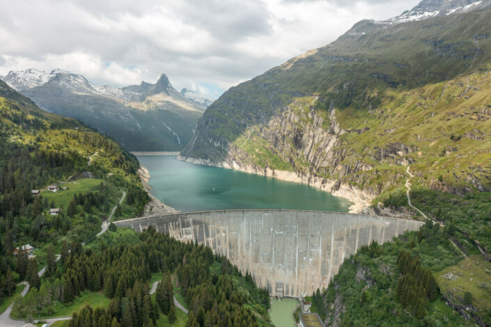 An aerial view of a dam in the mountains.