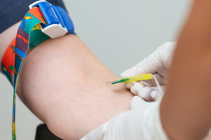 A person who has a blood test carried out in a doctor's surgery.