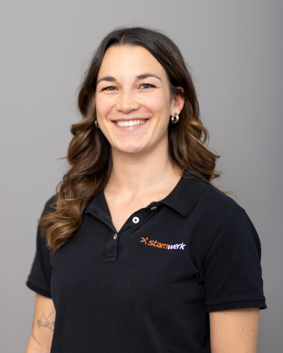 A smiling woman in a black polo shirt.