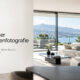 Modernes Wohnzimmer mit großen Fenstern und Blick auf einen See und die Berge, als Beispiel für einen Blogbeitrag über HDR in der Immobilienfotografie.